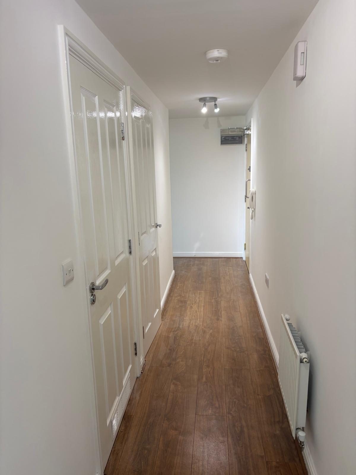 Hallway of the completed residential flat leading to the entrance door